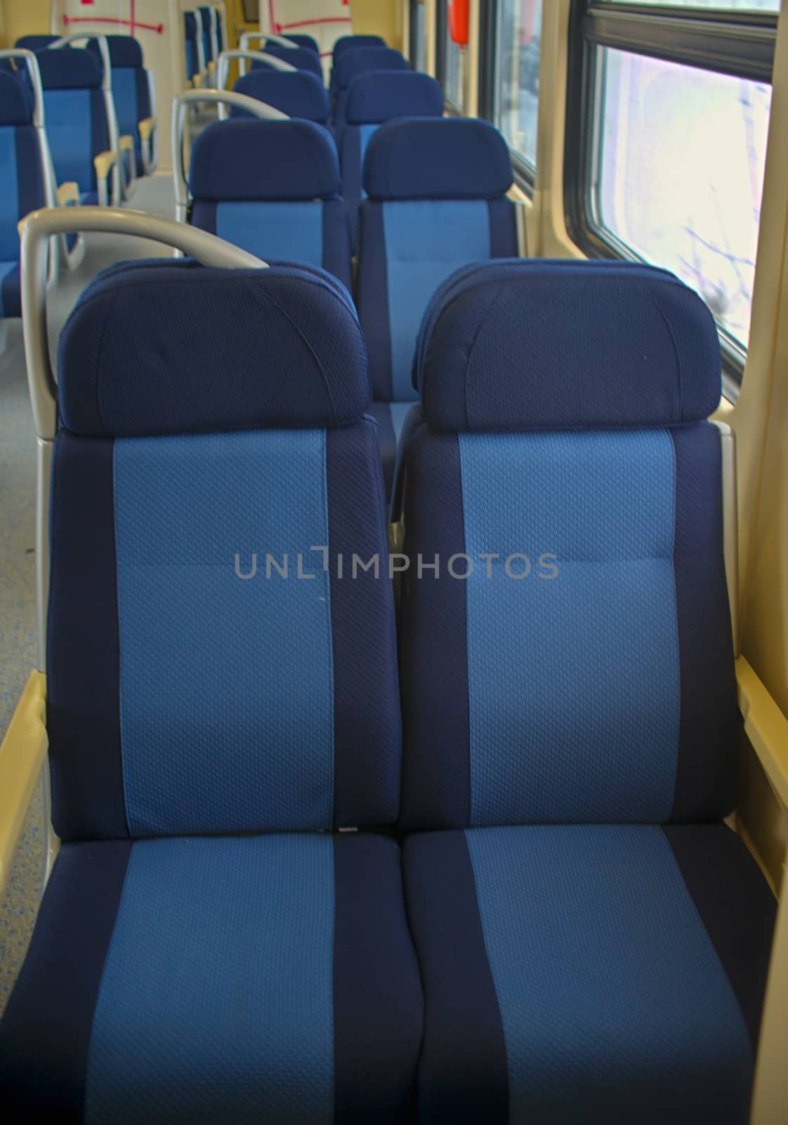 Row of empty seats in train wagon by sheriffkule