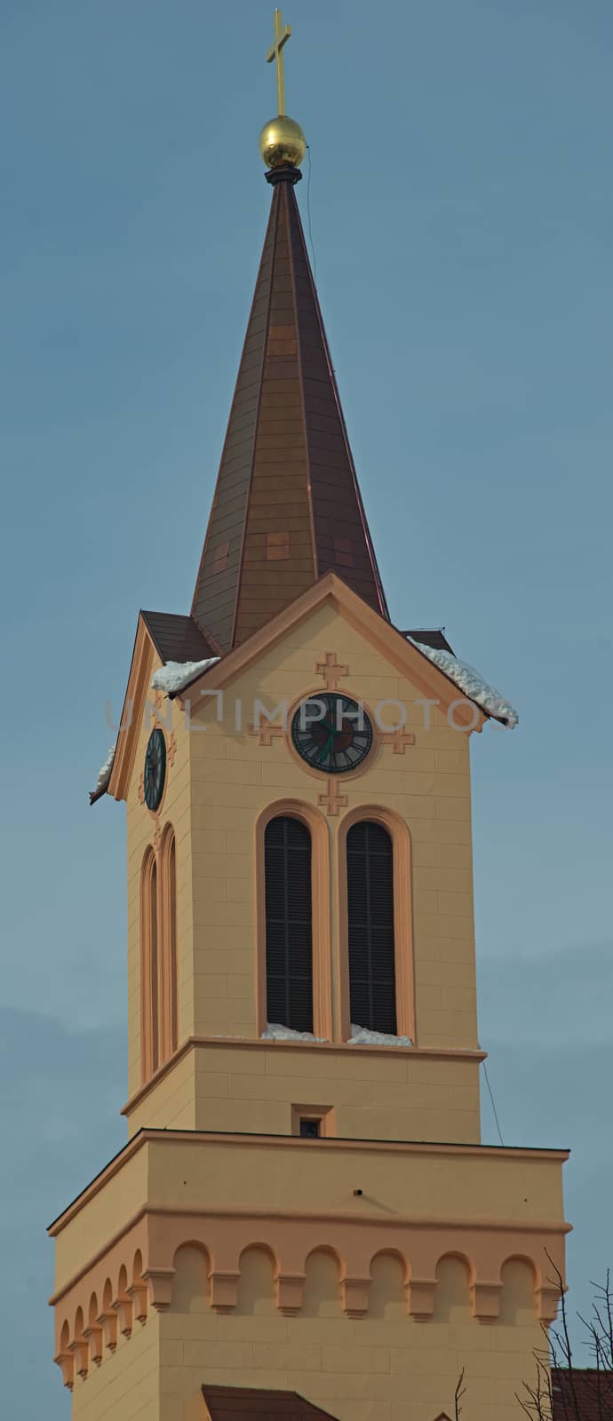 Fully reconstructed orange orthodox church bell tower