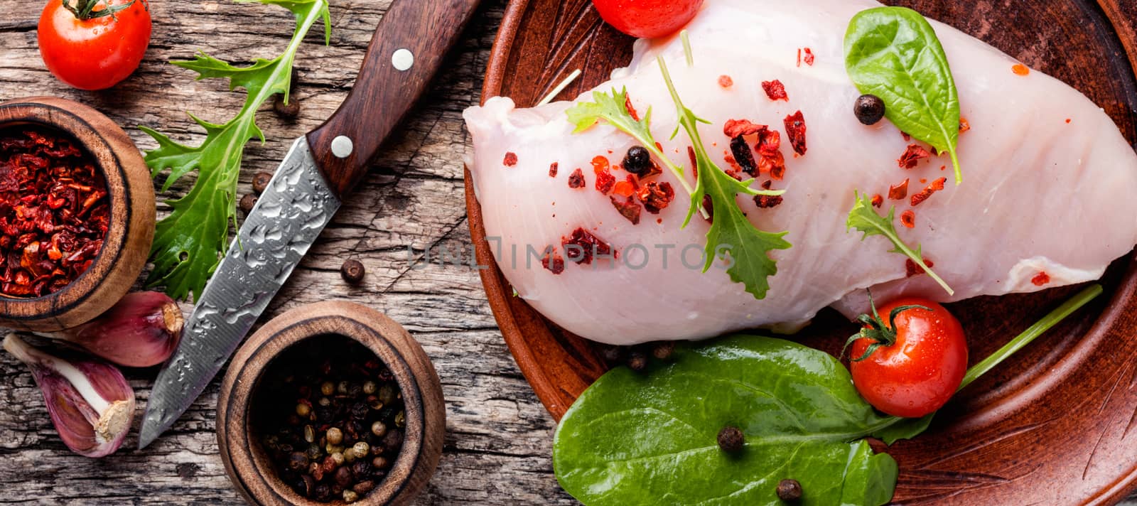 Fresh chicken with spices on vintage wooden background
