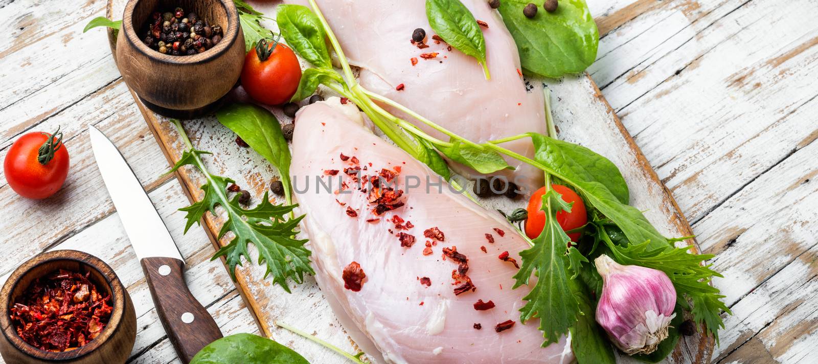 Fresh raw chicken on kitchen cutting board