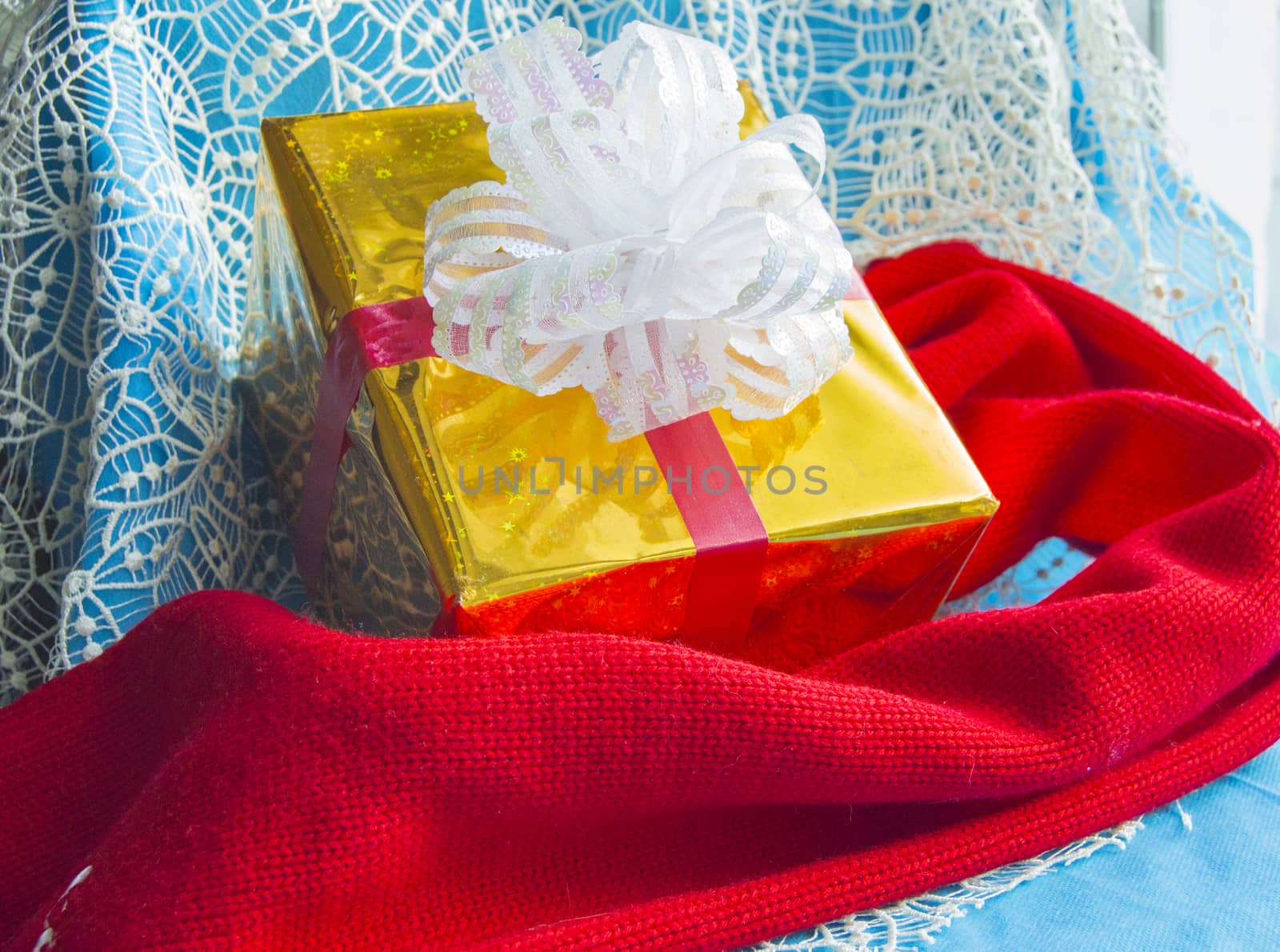 Gift box and red knit scarf, Christmas.
