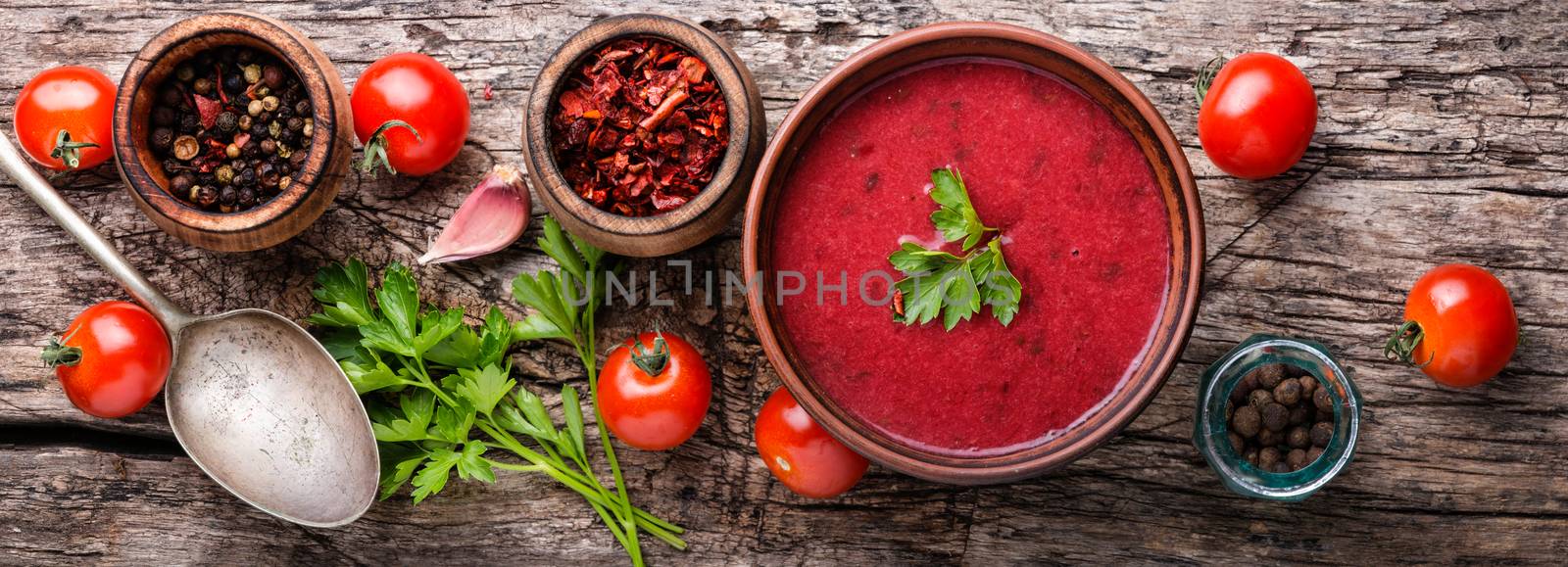 Fresh homemade tomato soup on wooden table.Long banner