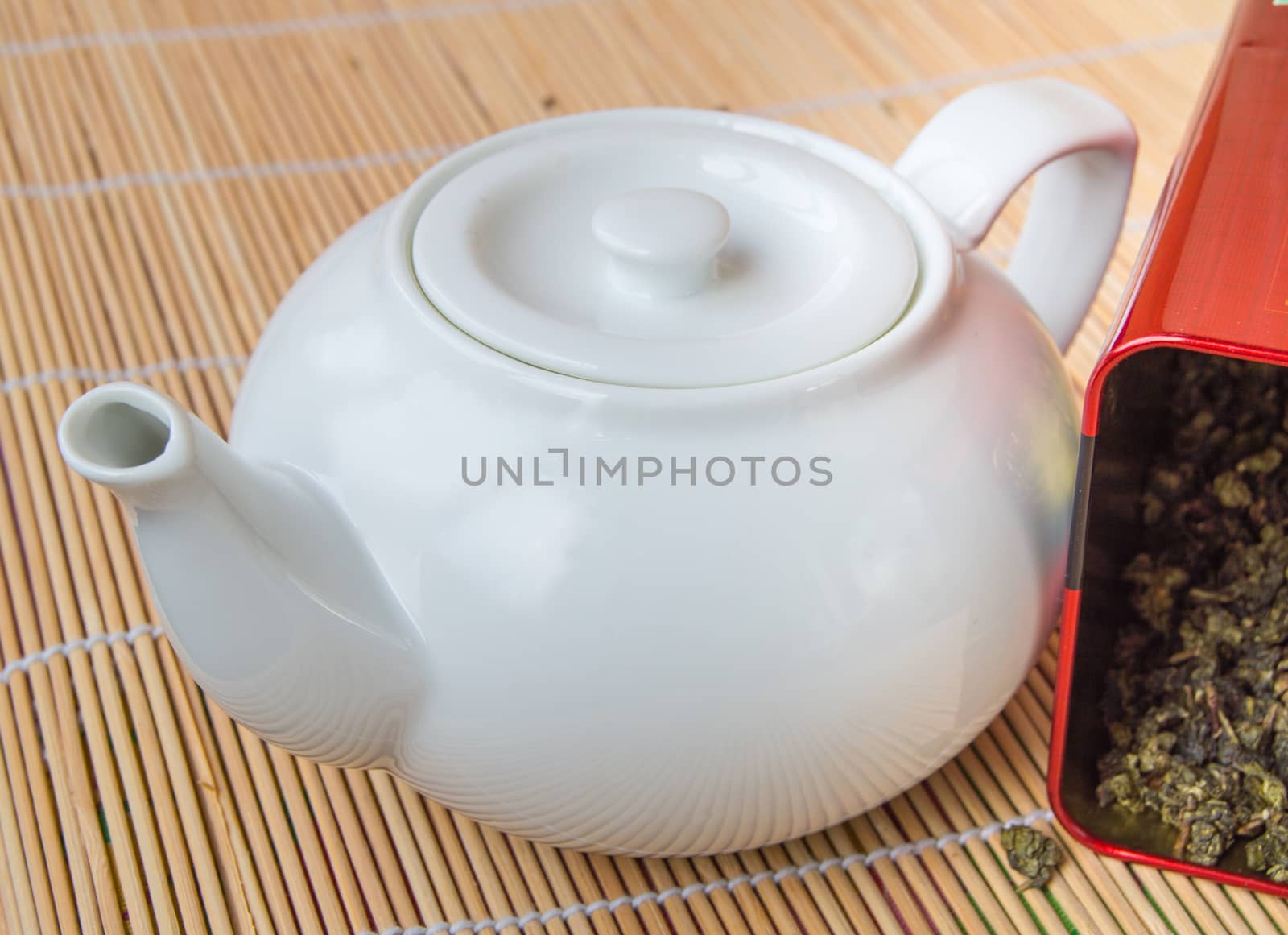 Teapot and a tin of traditional Asian green tea loose by claire_lucia