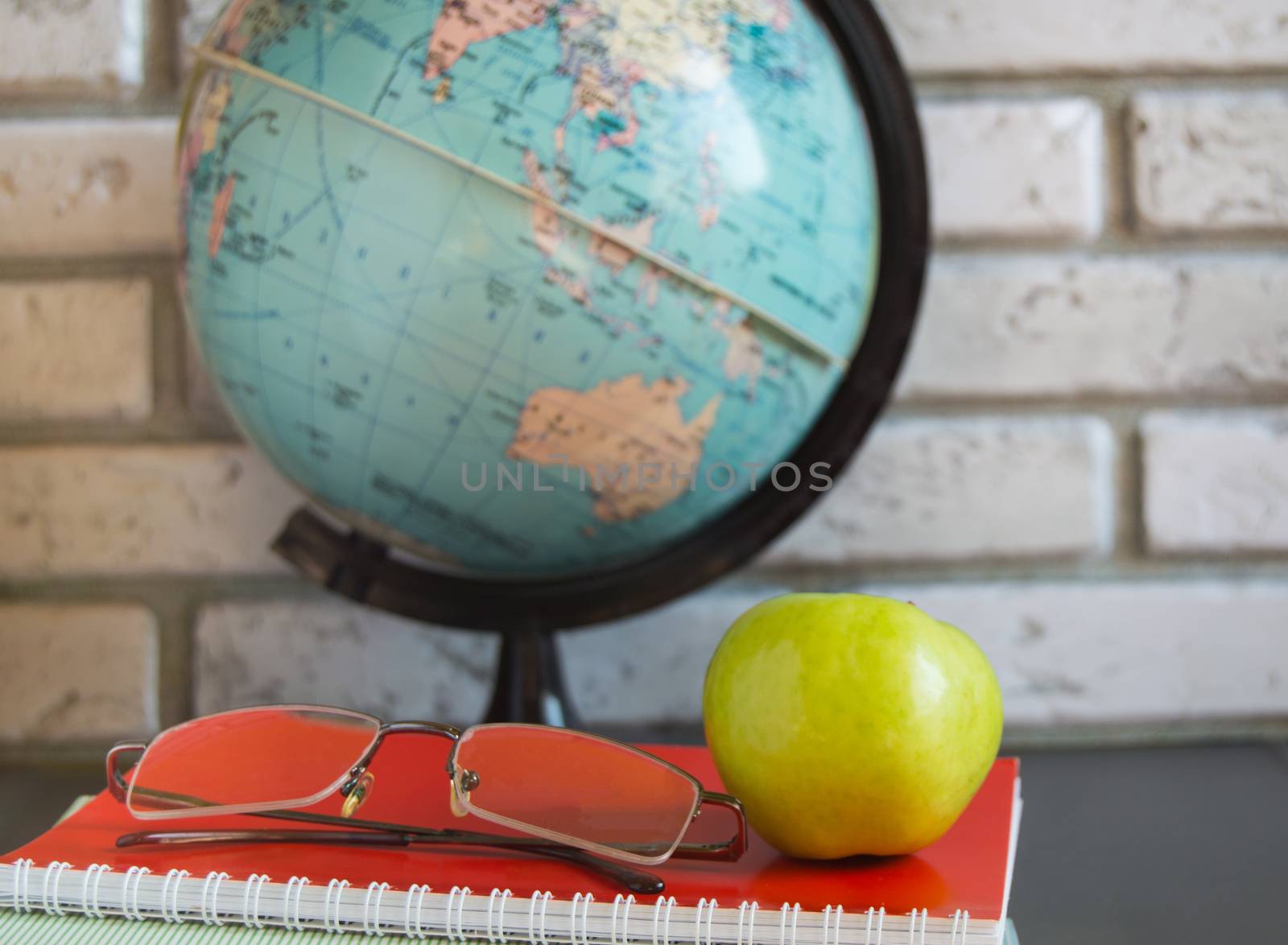 World teachers ' Day in school. Still life with books, globe, Apple glasses