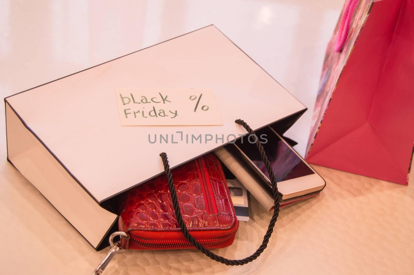 Closeup of bag with a purchase card, wallet, phone. Concept sales, black Friday.