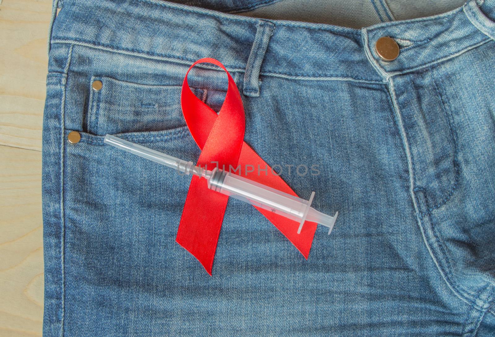 awareness AIDS red ribbon on jeans, a symbol of opposition