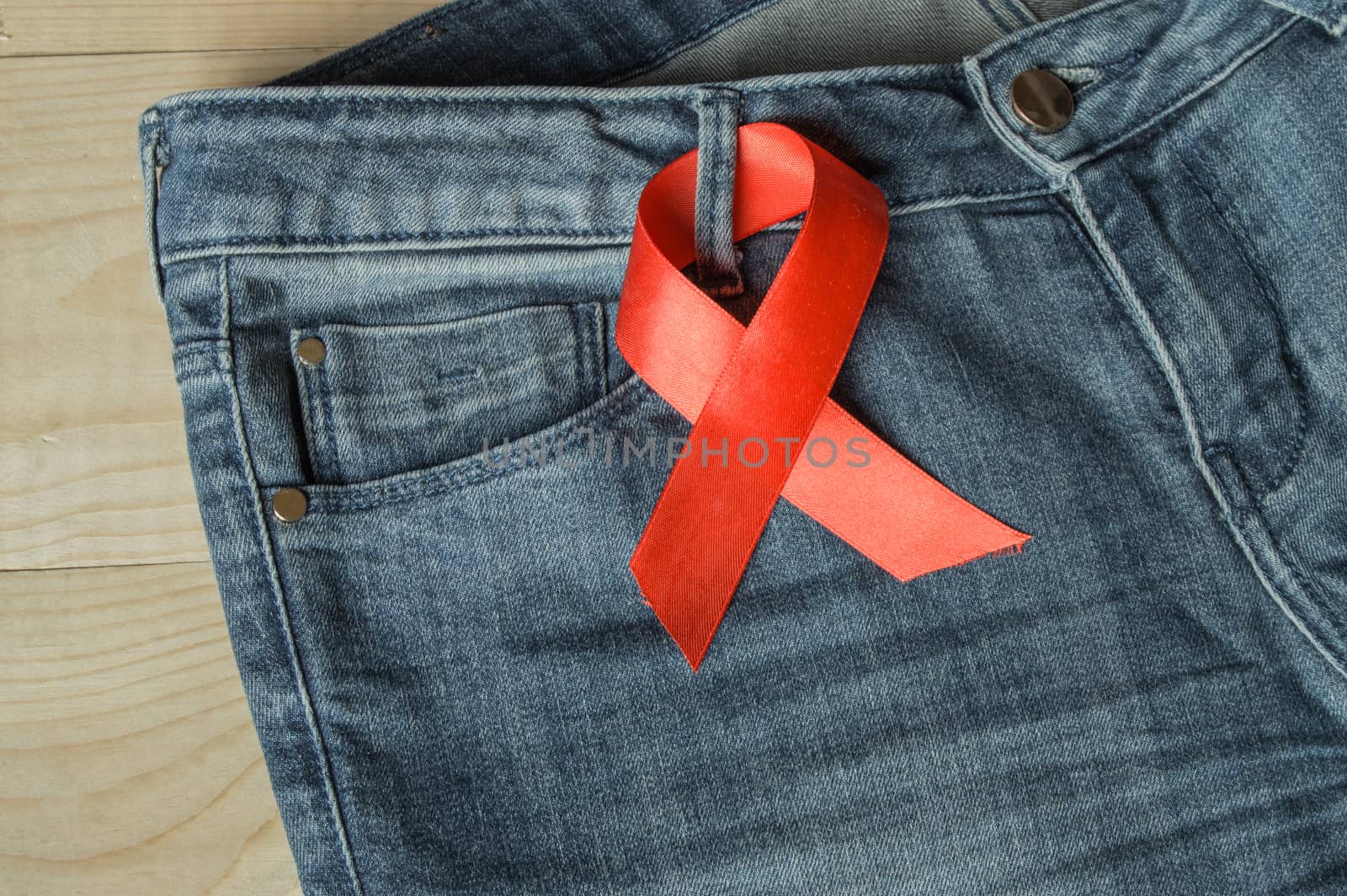 Red ribbon on the Genie is a symbol of struggle and awareness AIDS.