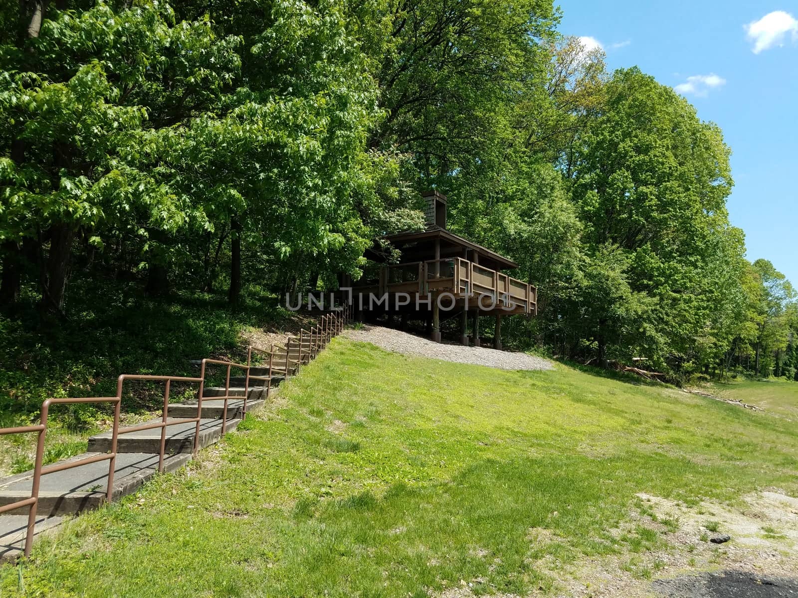 picnic shelter structure or building on stilts on grass hill