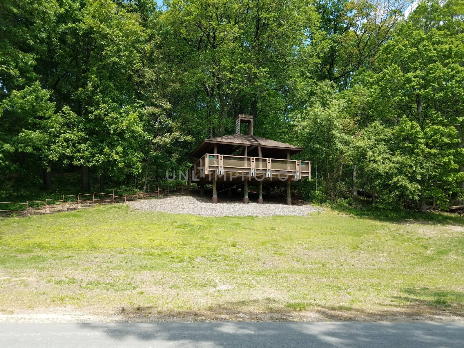 picnic shelter structure or building on stilts on grass hill