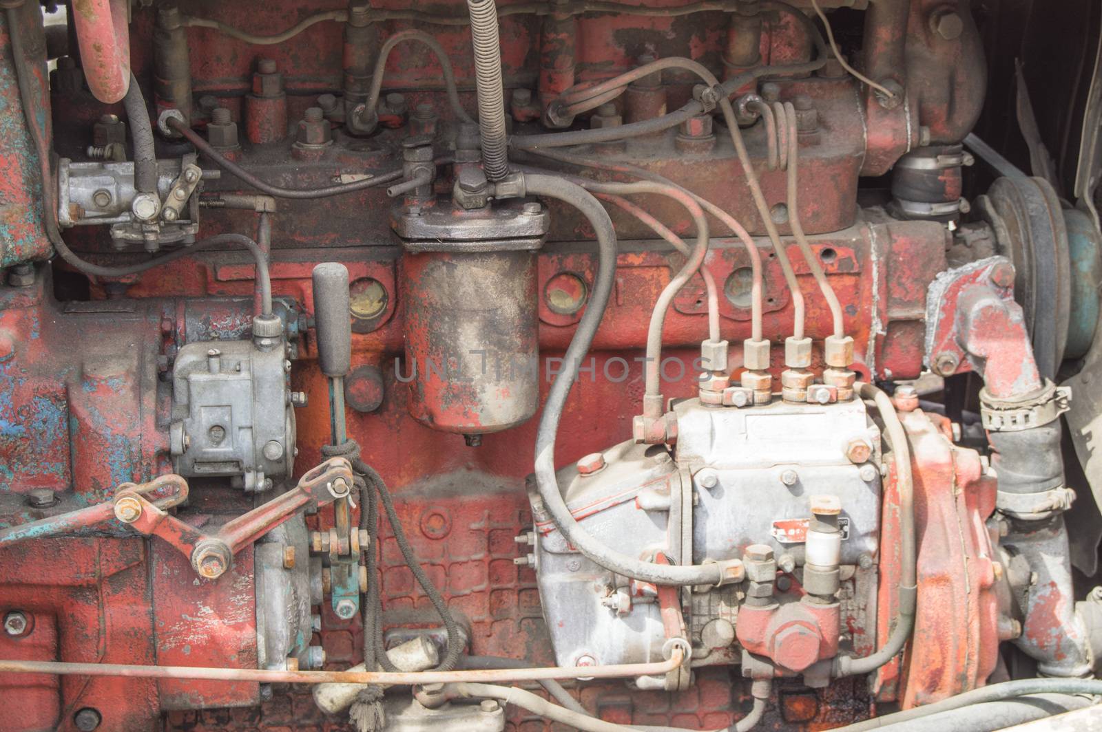 Close-up of old dirty tractor diesel engine parts.