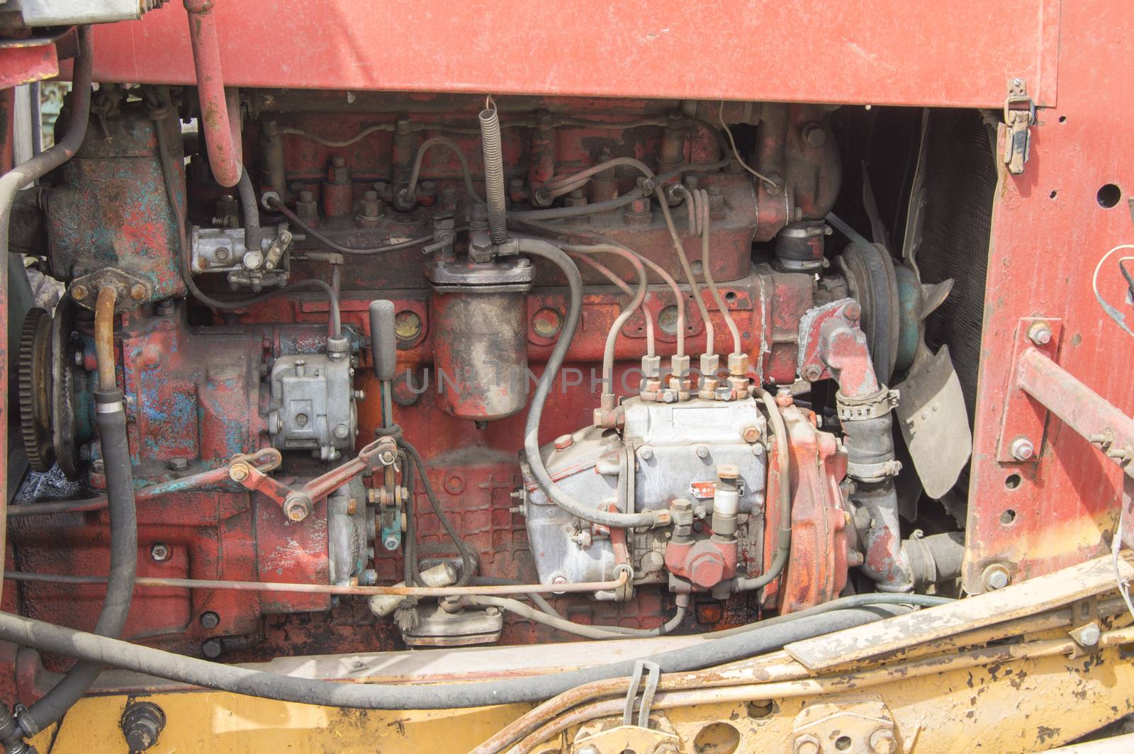 Close-up of old dirty tractor diesel engine parts.