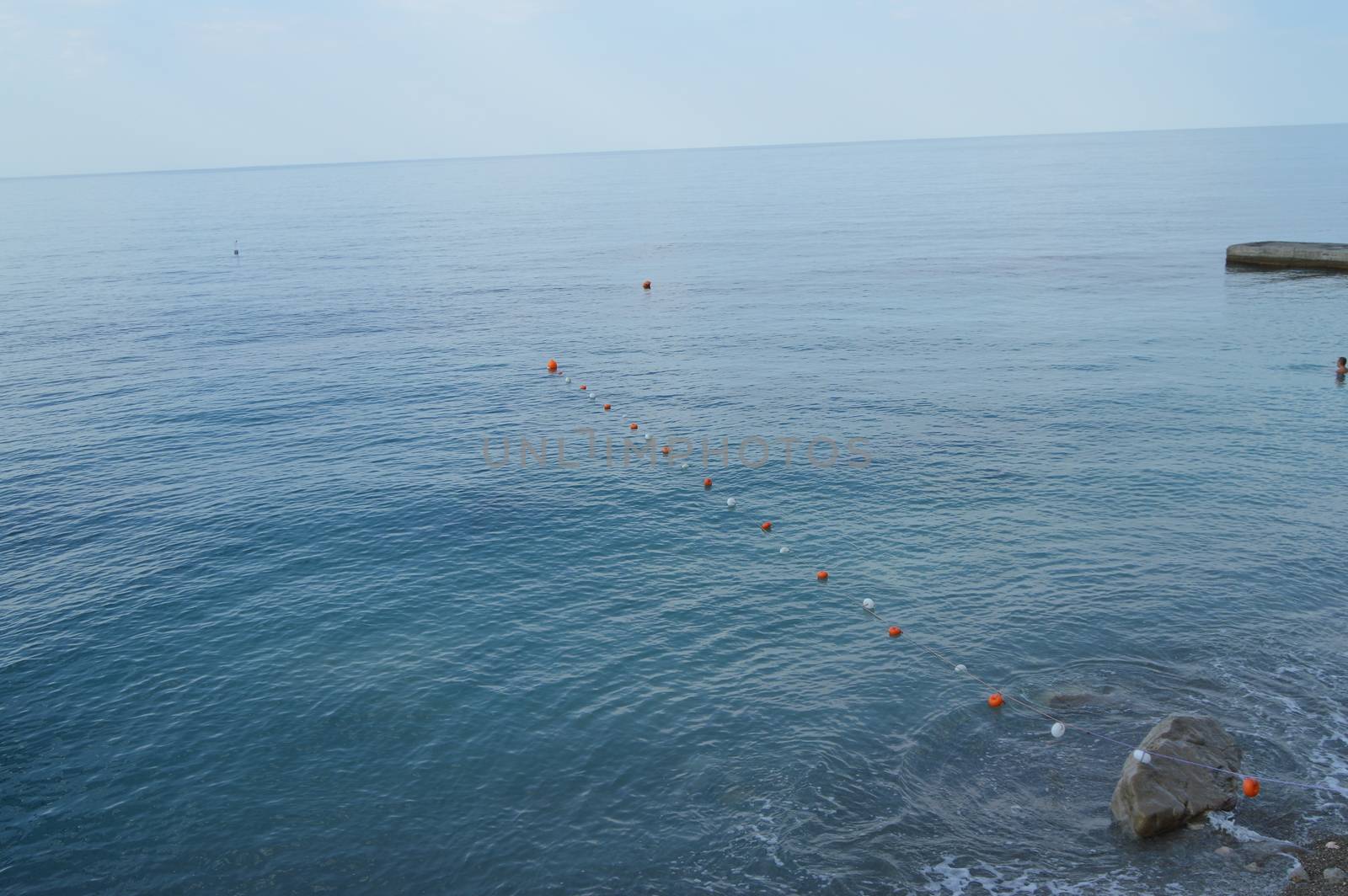 Separation buoys in the sea for safe swimming on the beach.