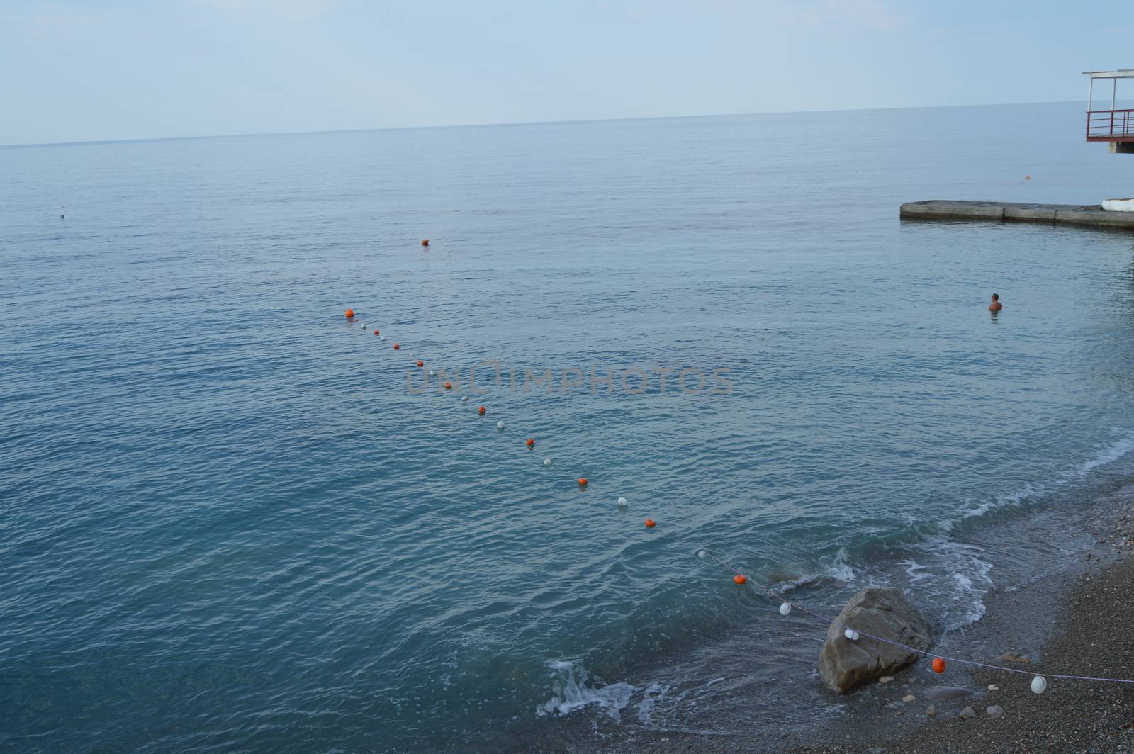 Separation buoys in the sea for safe swimming on the beach by claire_lucia