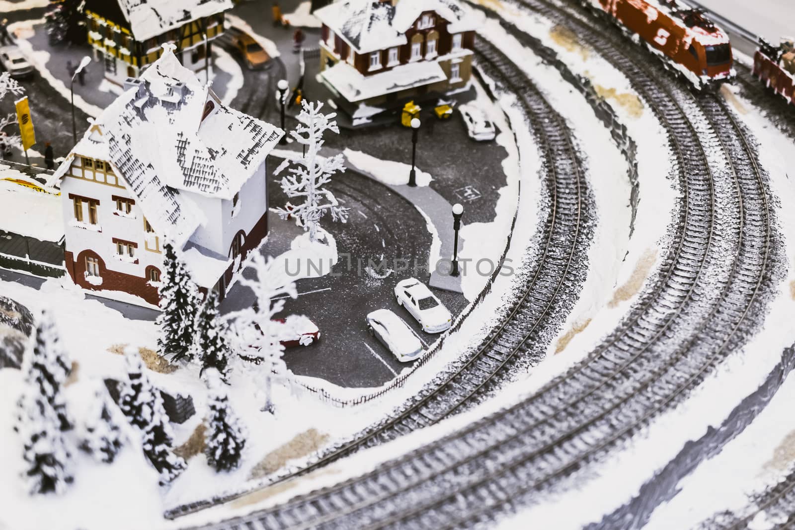 miniature city in winter - with houses, roads, cars, railway