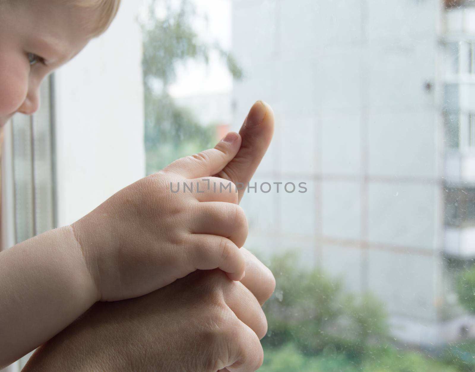 concept of a happy family - an adult holds the hand of a baby by claire_lucia