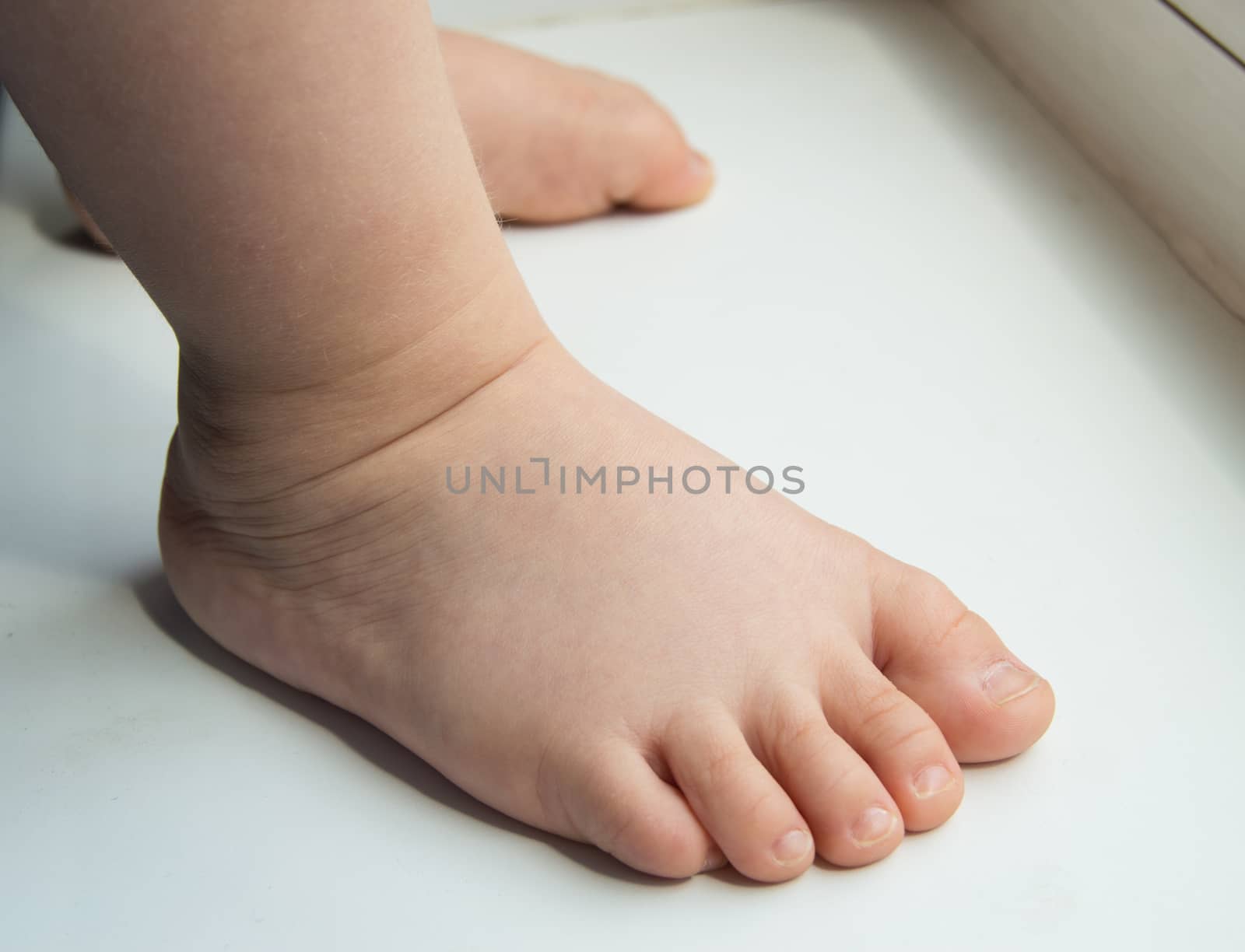 adorable baby little feet stand, first steps, close-up by claire_lucia