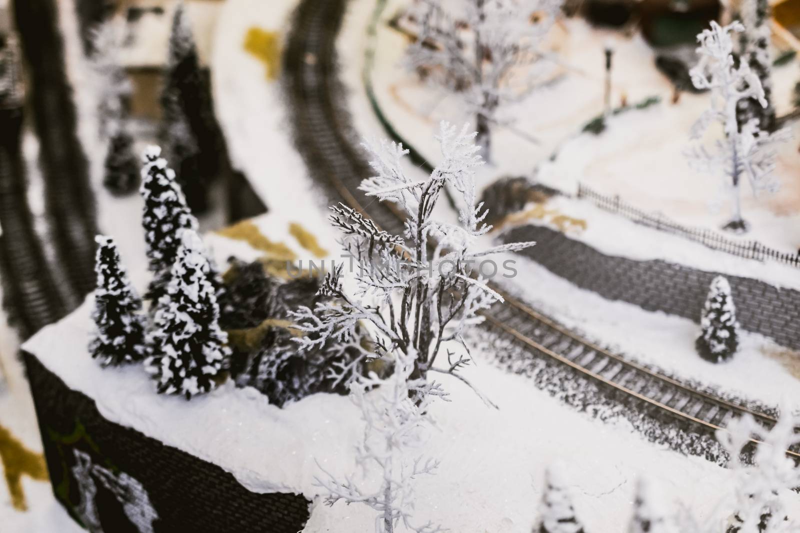 miniature city in winter - with houses, roads, cars, railway