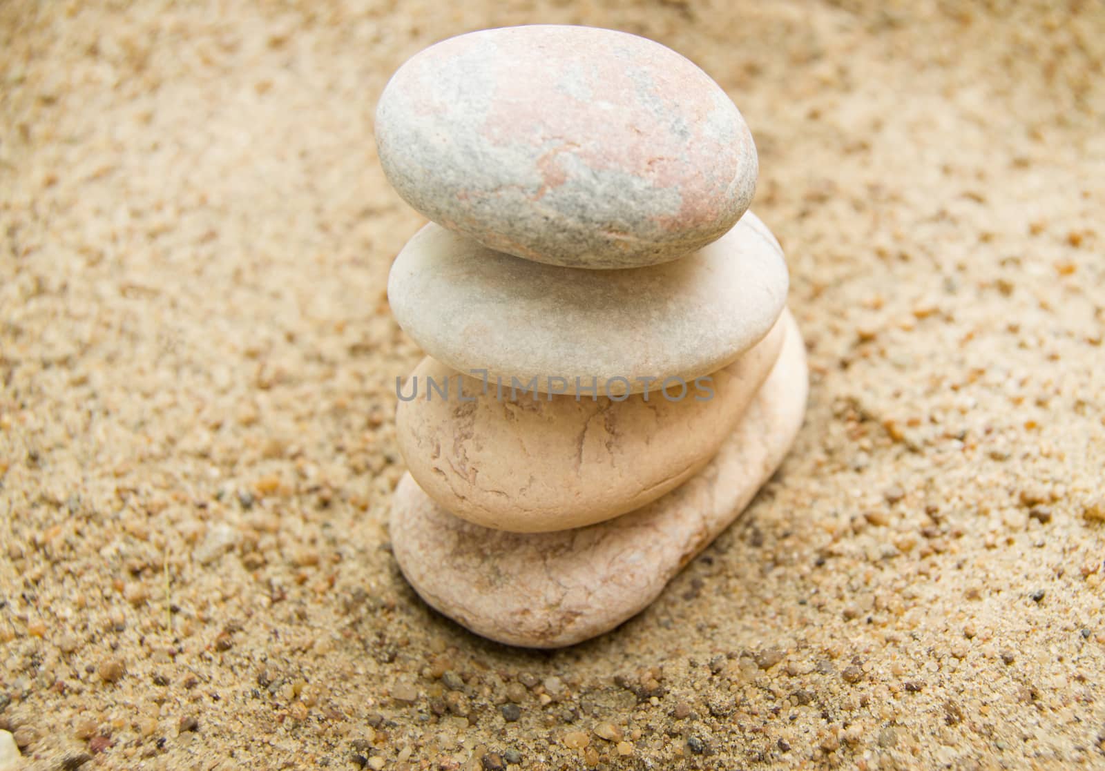 Zen stones on the beach for a perfect meditation, a blurred back by claire_lucia