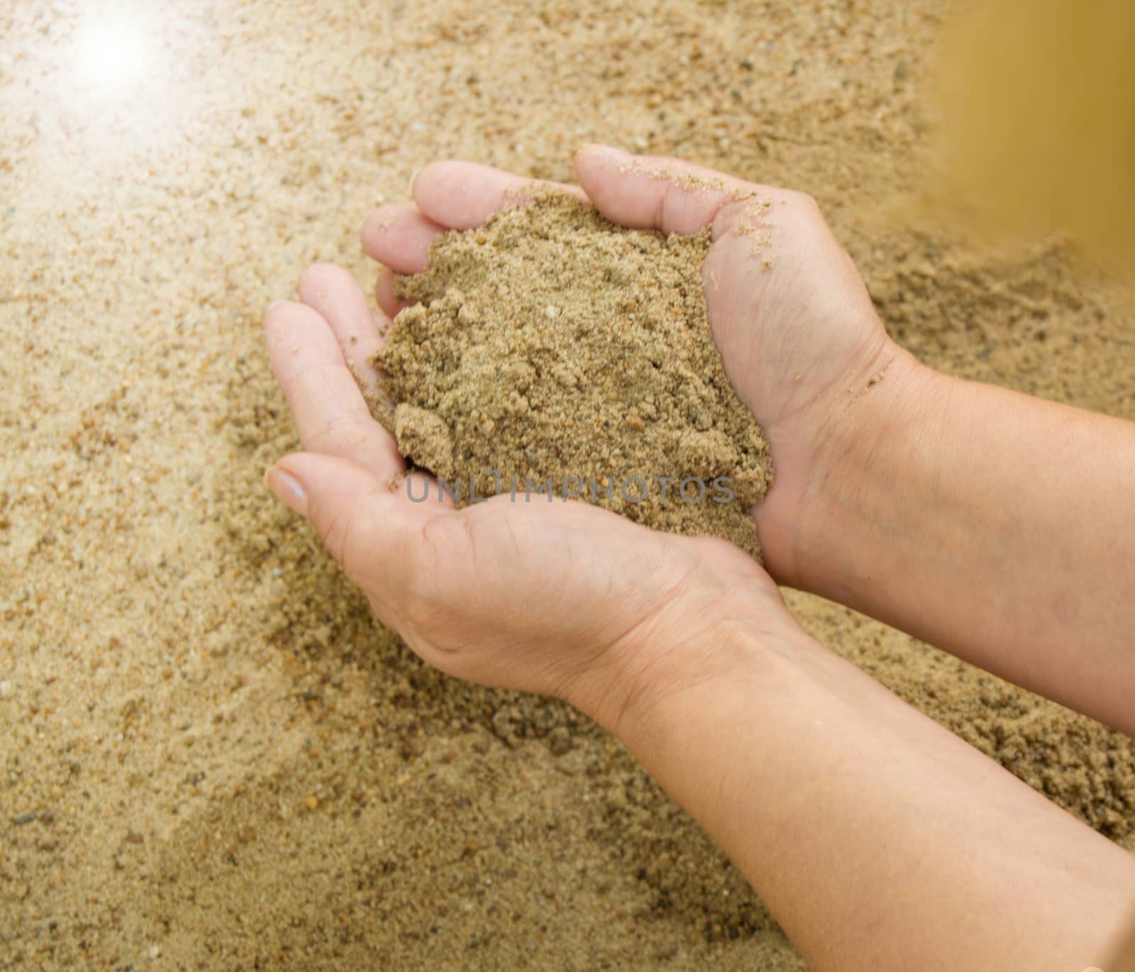 Female hands with sand, the concept of vacation and holidays.