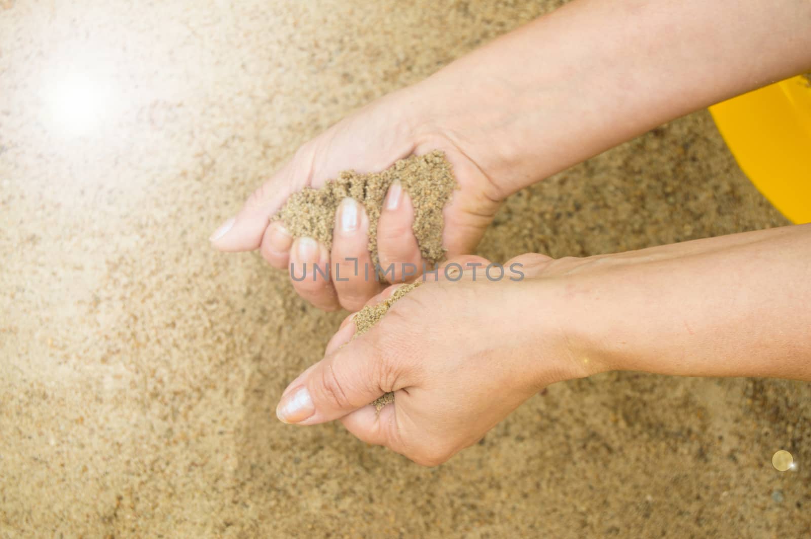 Female hands with sand, the concept of vacation and holidays.