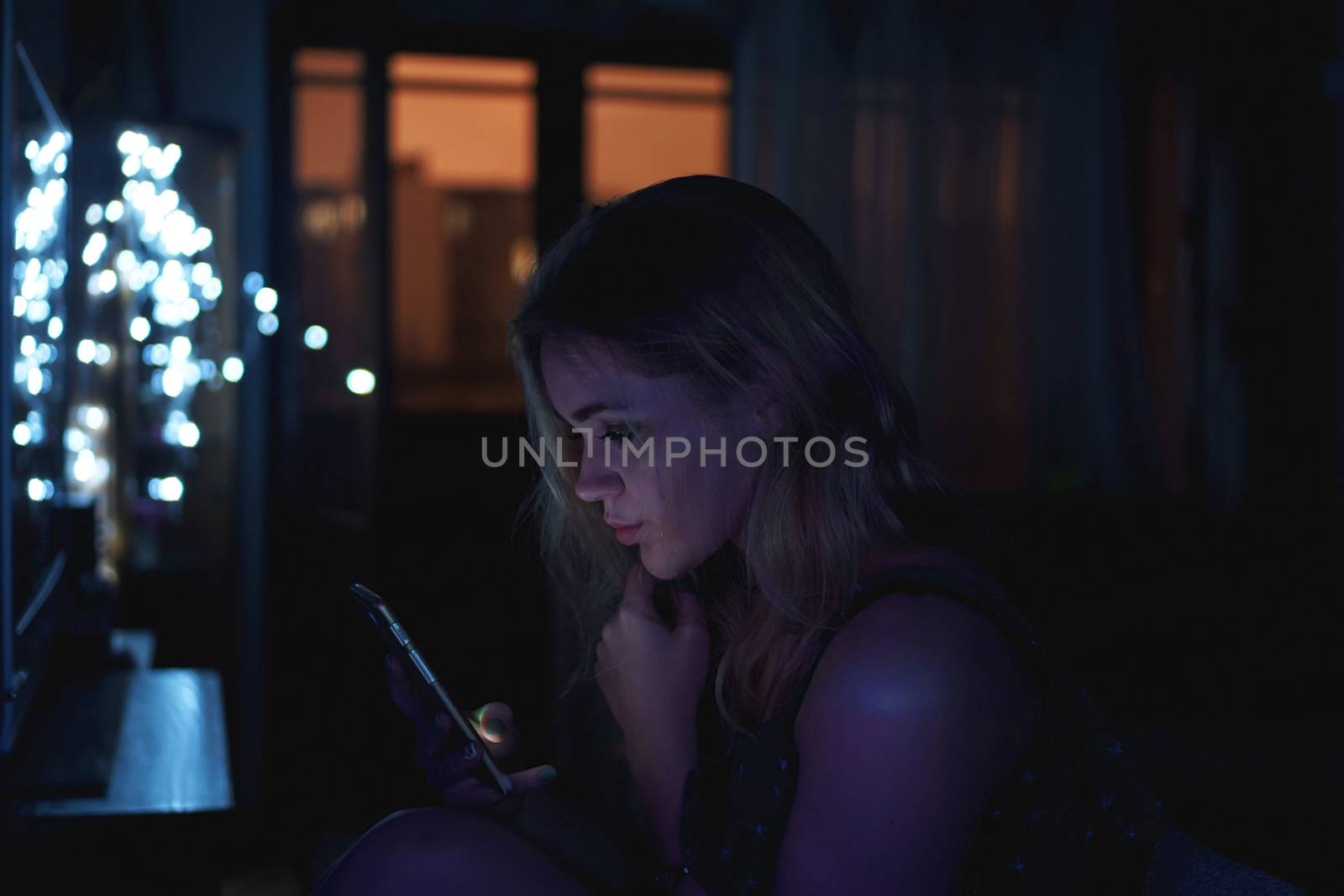 Girl using cellphone at night with neon light - pink and blue by natali_brill