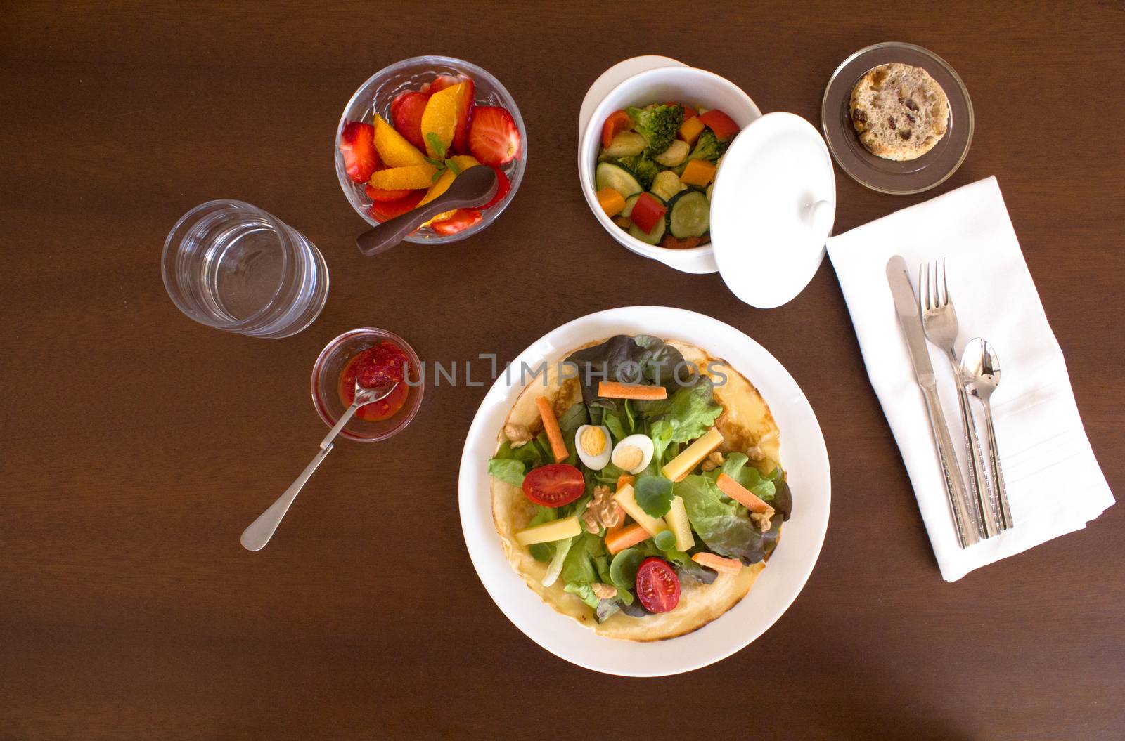 Full healthy menu composed of salad, chicken with vegetables, bread and fruit salad