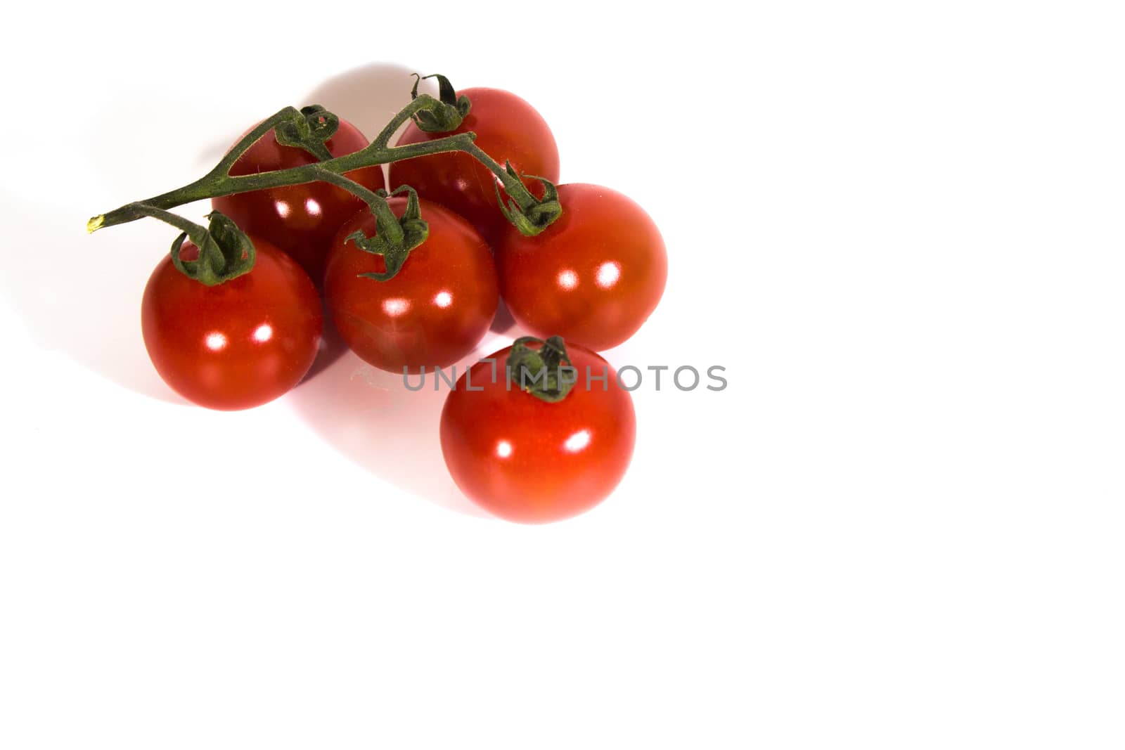 six cherry tomatoes with a white background