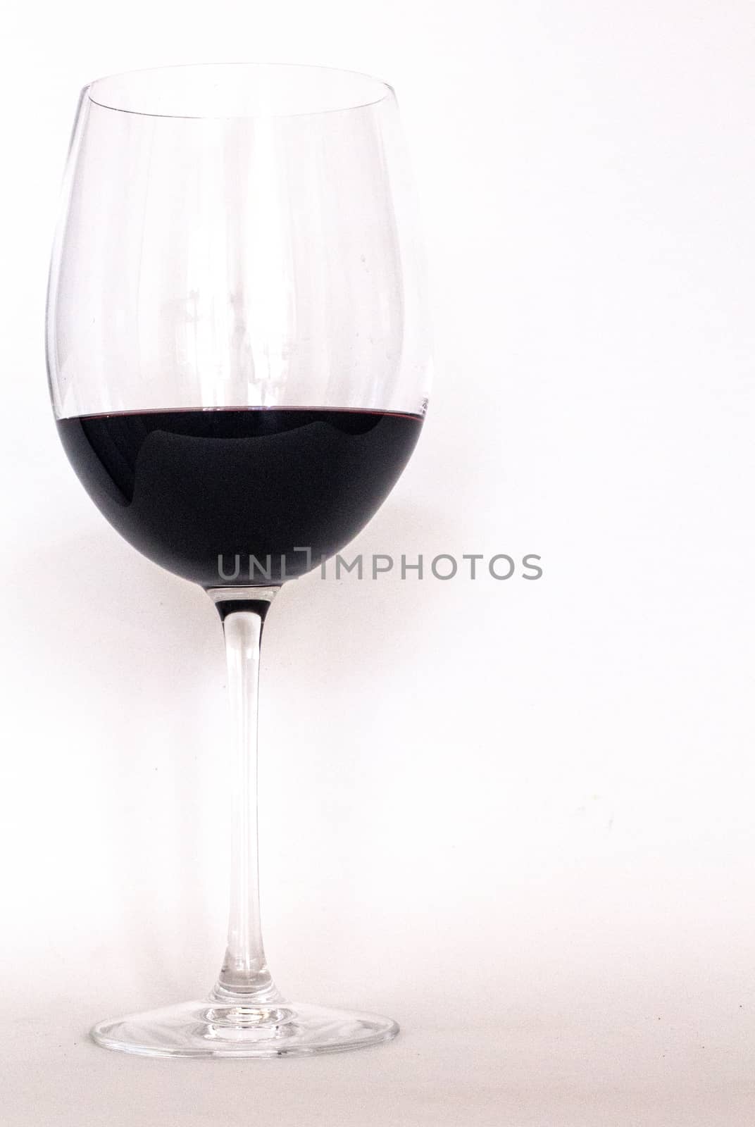 Glass of red wine with white background by Joanastockfoto