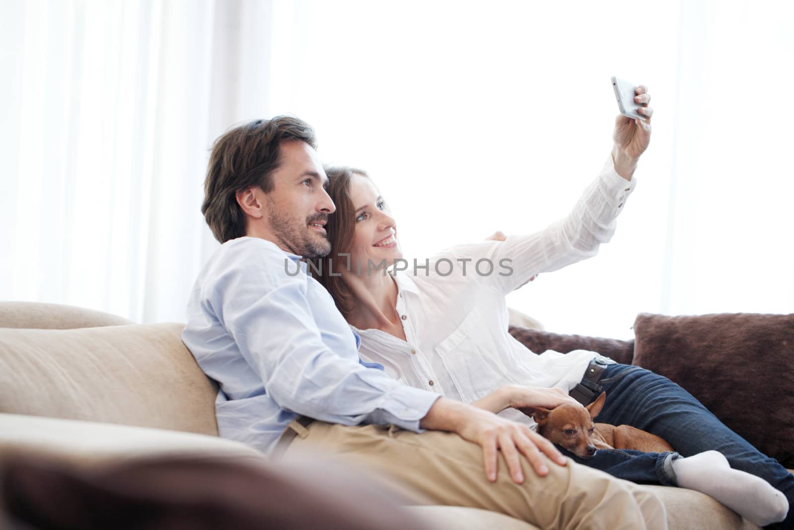 Happy couple taking selfie  by ALotOfPeople