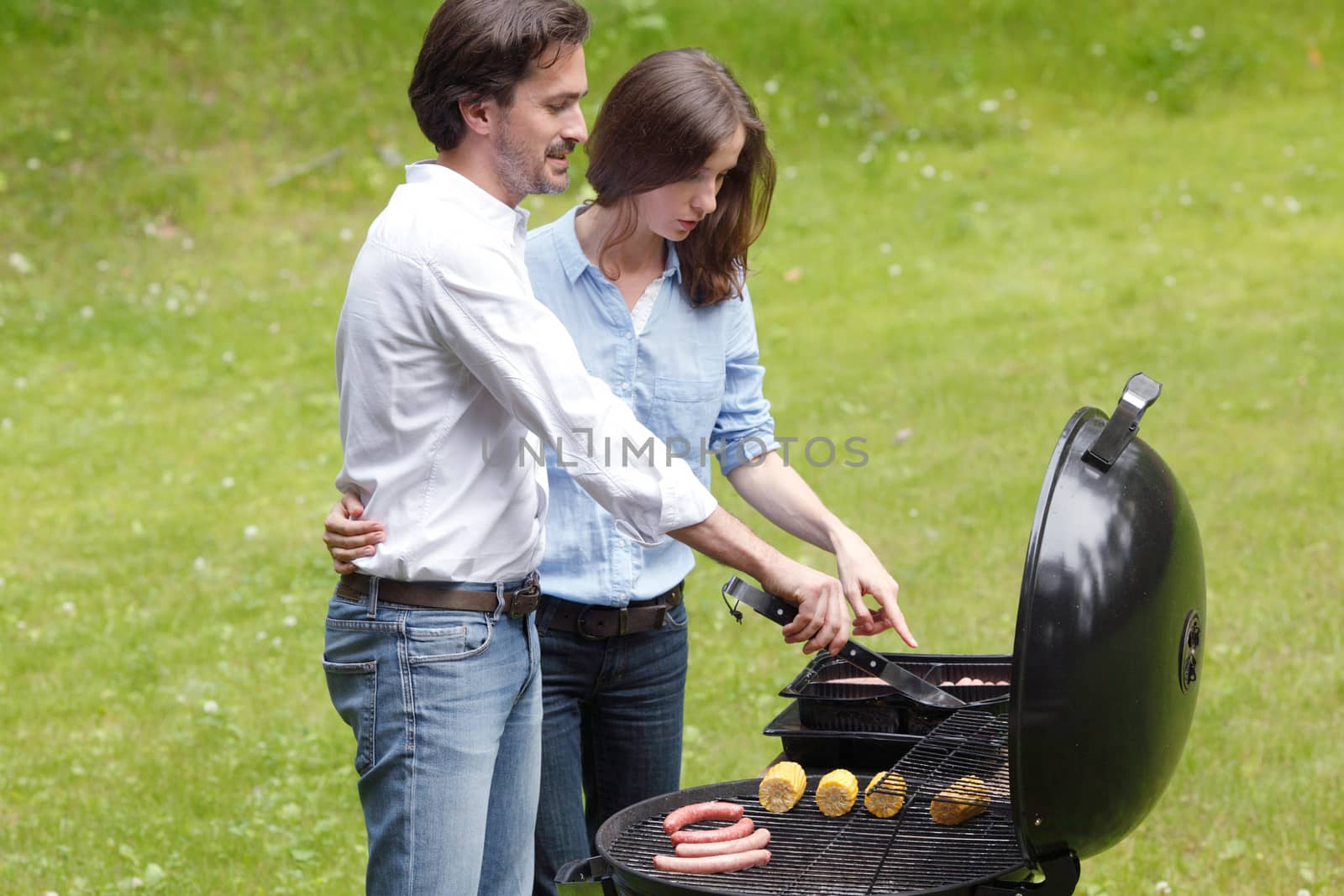 Couple cooking on barbecue  by ALotOfPeople