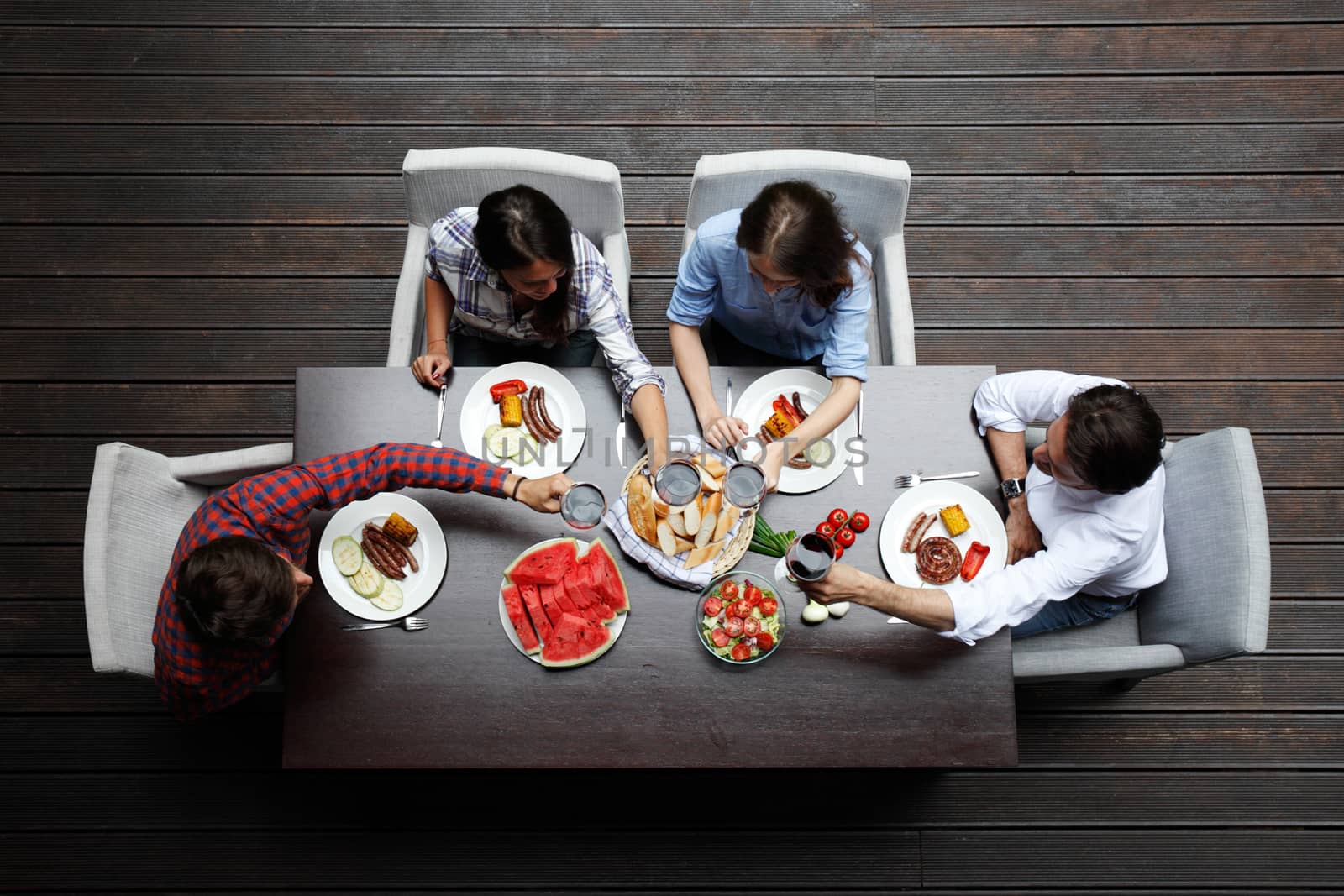 Four friends having dinner, top view