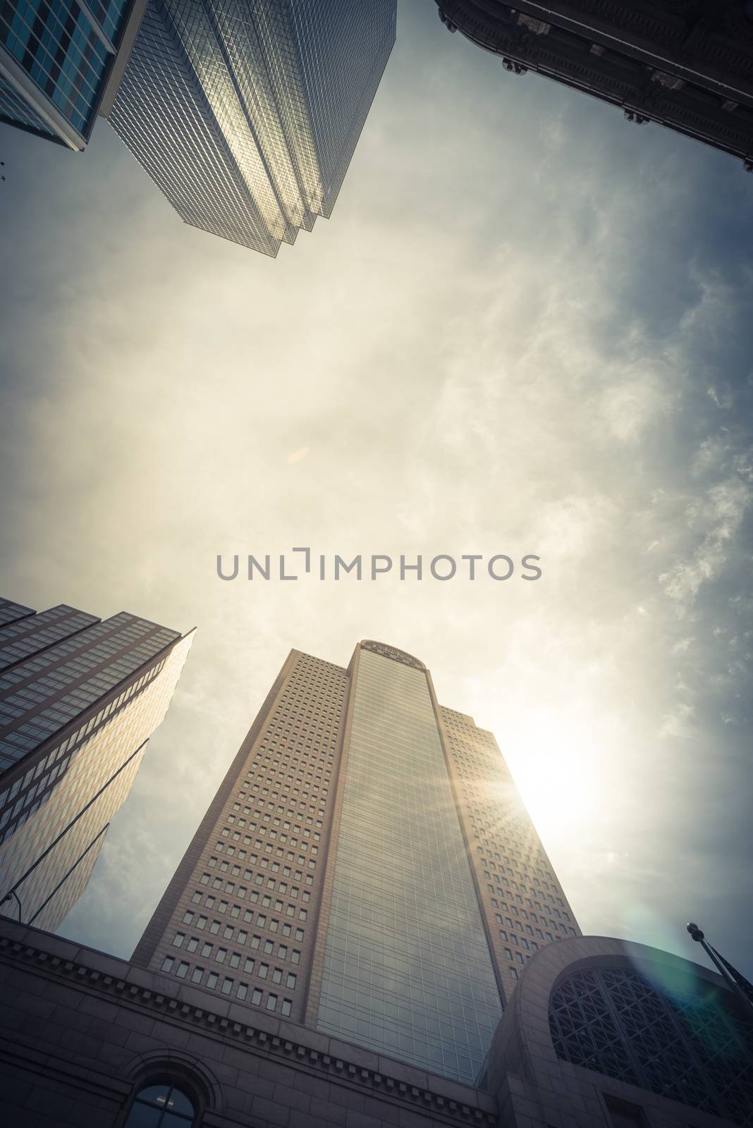 Low perspective angle view of Dallas skylines with cloud blue sky by trongnguyen