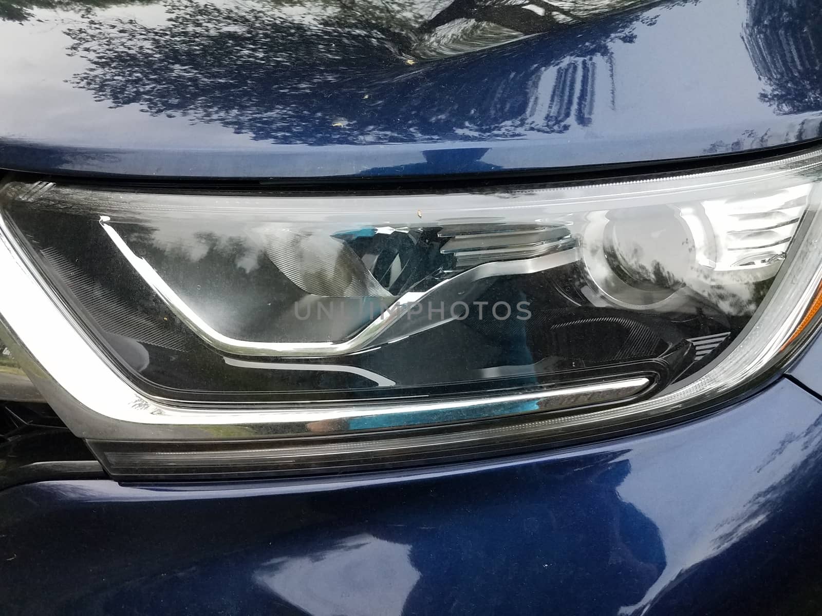 front of blue car or automobile with glass head light
