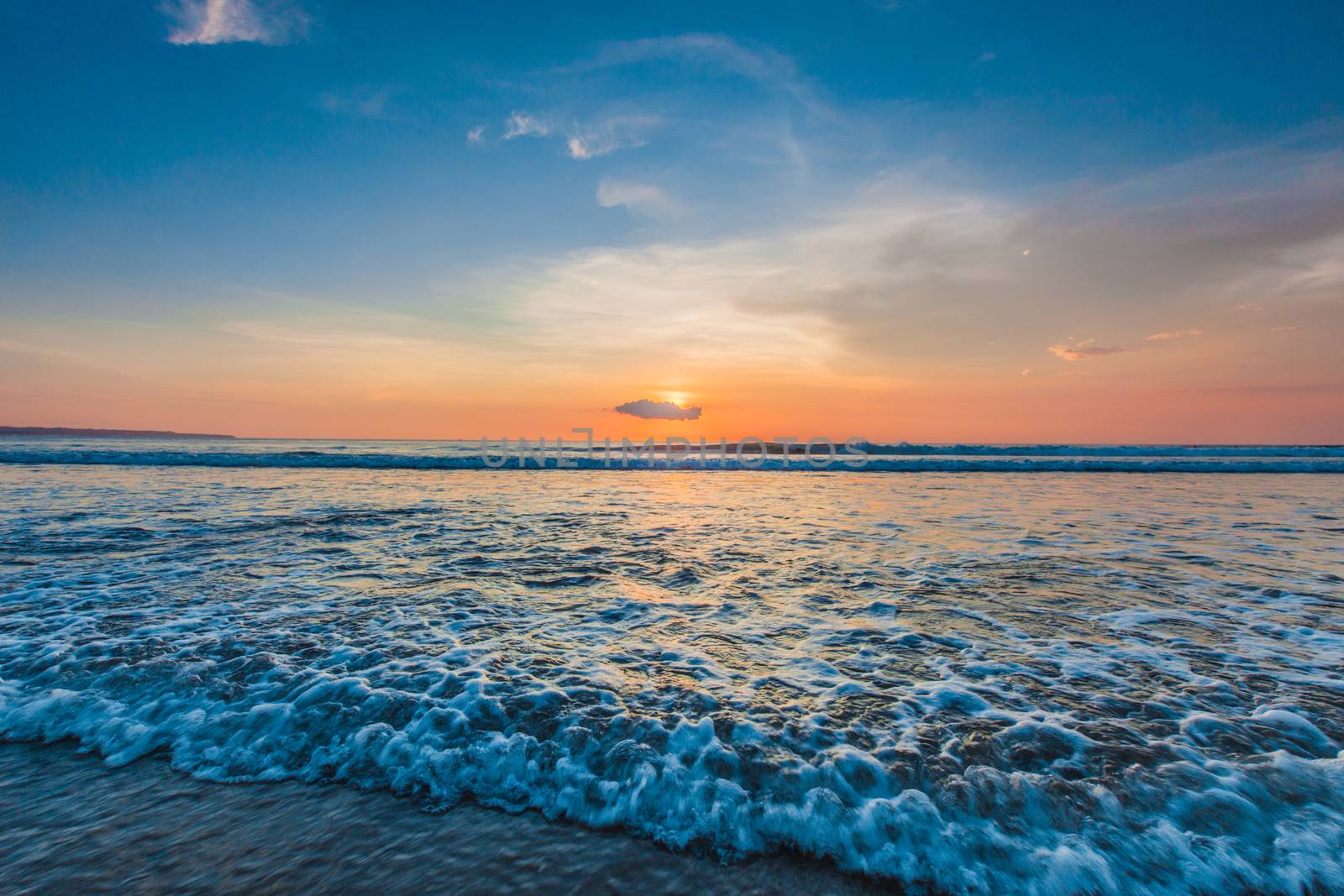 Amazing colorful sunset over sea form Bali beach