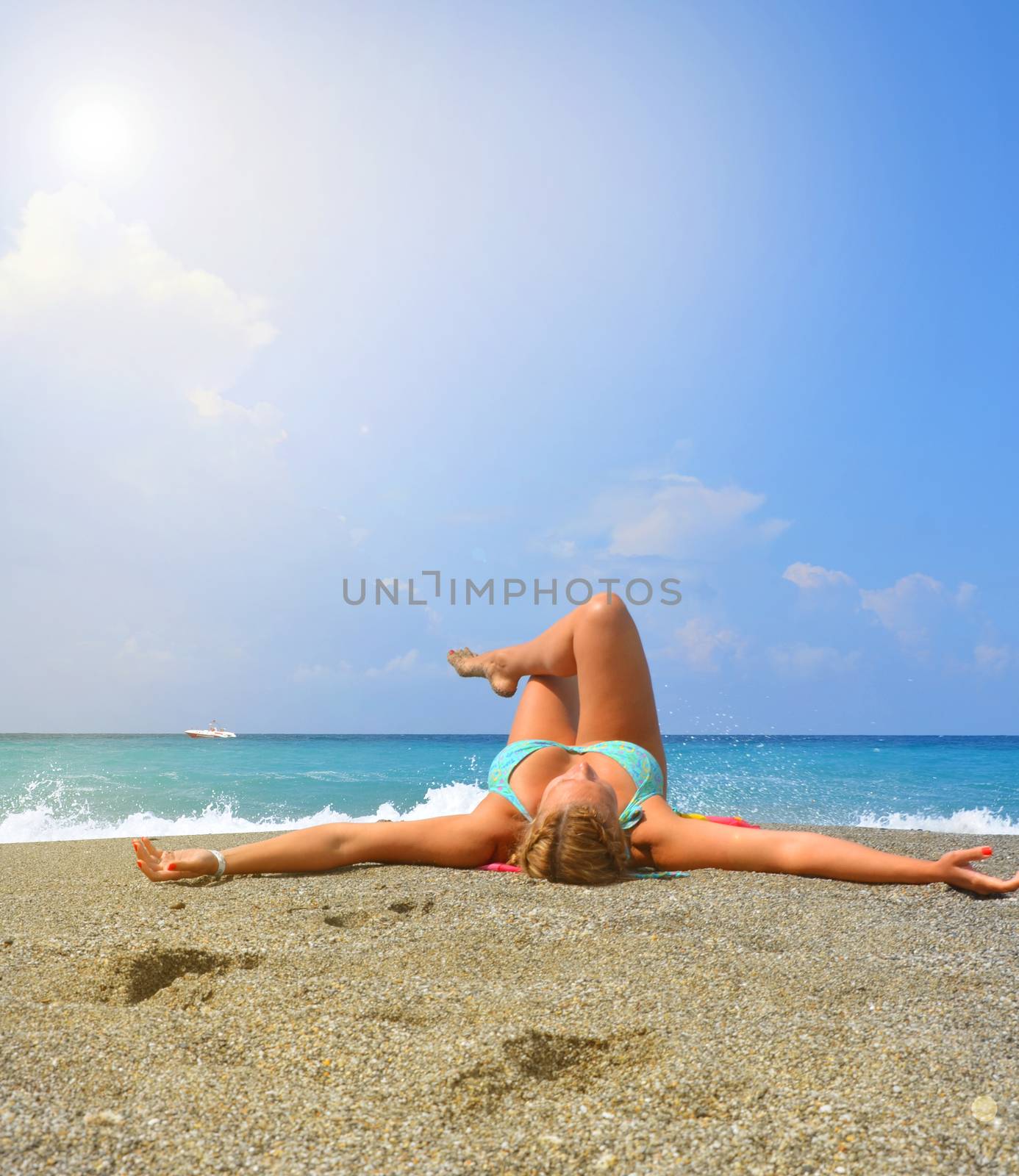 Happy young woman in bikini and hat sunbathing on tropical beach, luxury vacation concept, copy space by claire_lucia