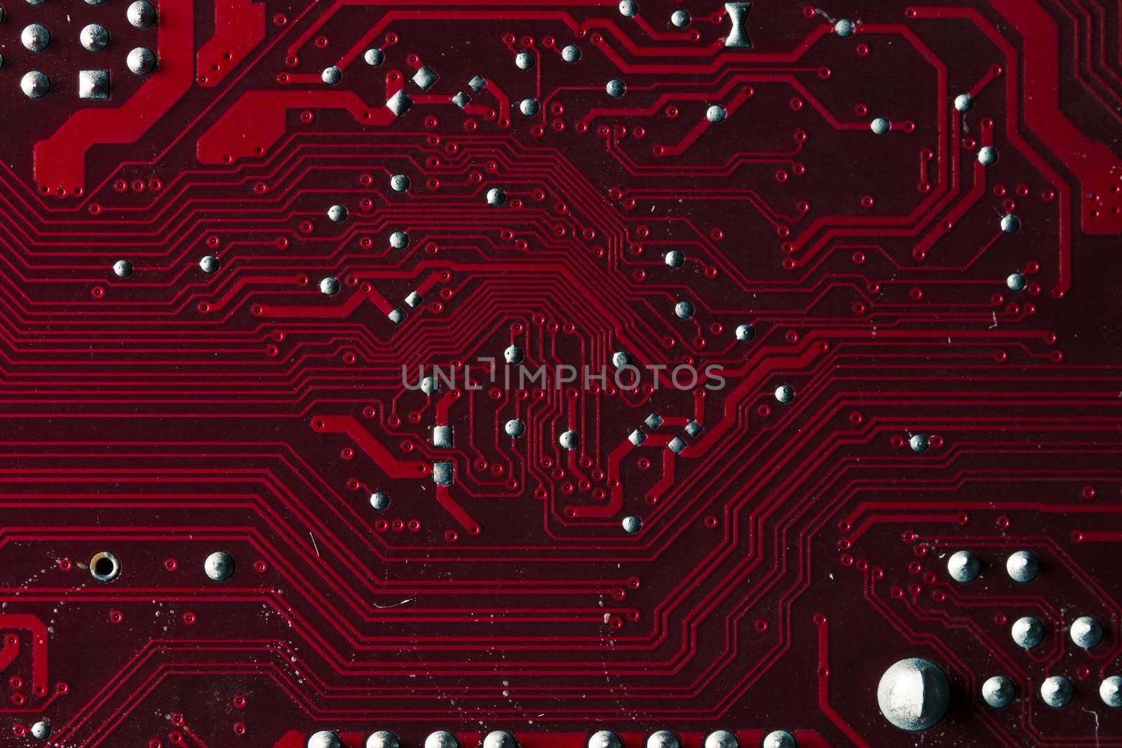 Macro picture of red printed circuit board with chips