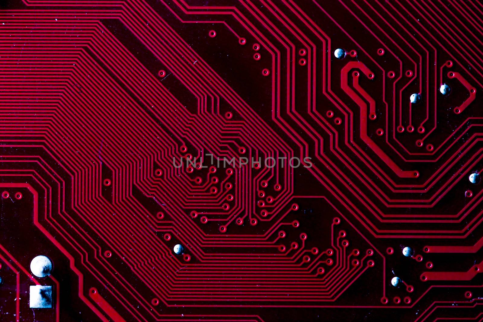 Macro picture of red printed circuit board with chips