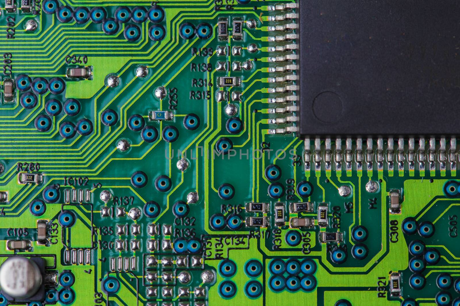 Macro picture of red printed circuit board with chips