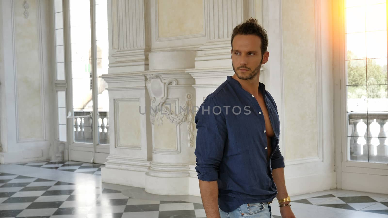 Full Body Shot of a Thoughtful Handsome Young Man, Holding a Guide, Looking Away Inside a Museum