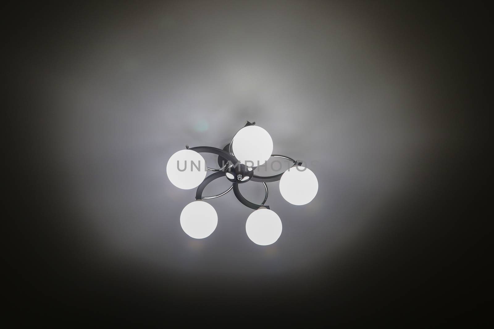 Beautiful chandelier with five shades of white frosted glass