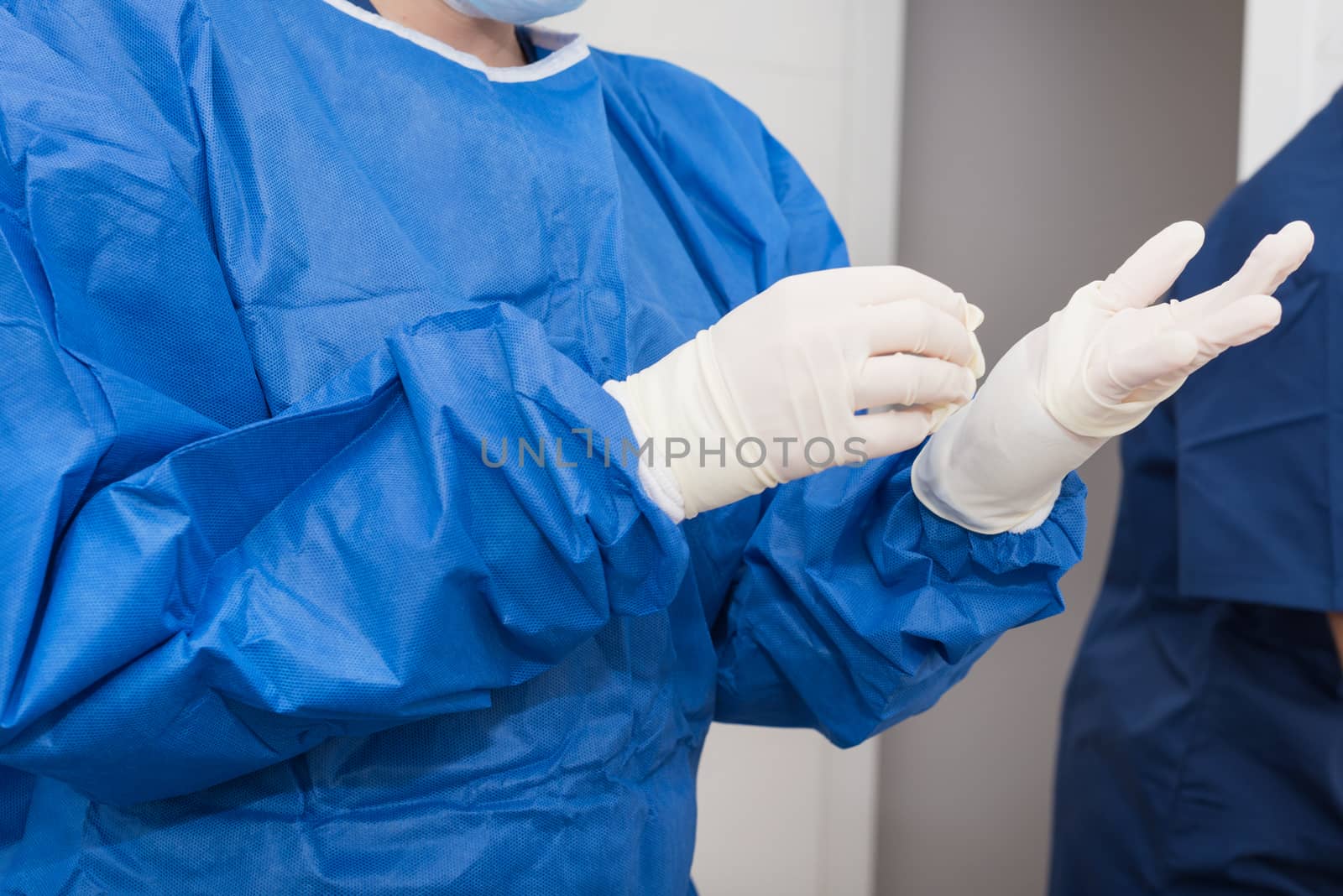 Nurse putting on surgical gloves