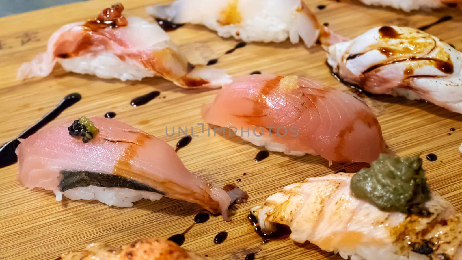 The close up of Japanese sushi set on wooden board in Japan restaurant.