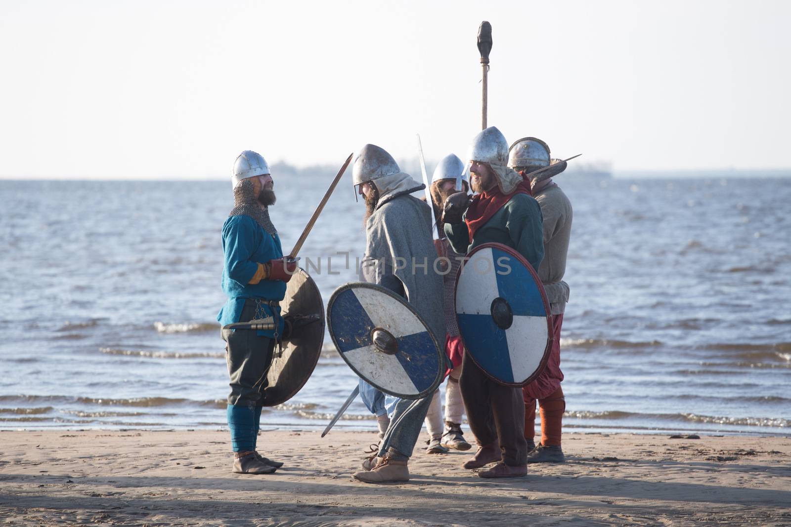 Slavic warriors reenactors with wearpons and shields getting ready for training outdoors at seaside