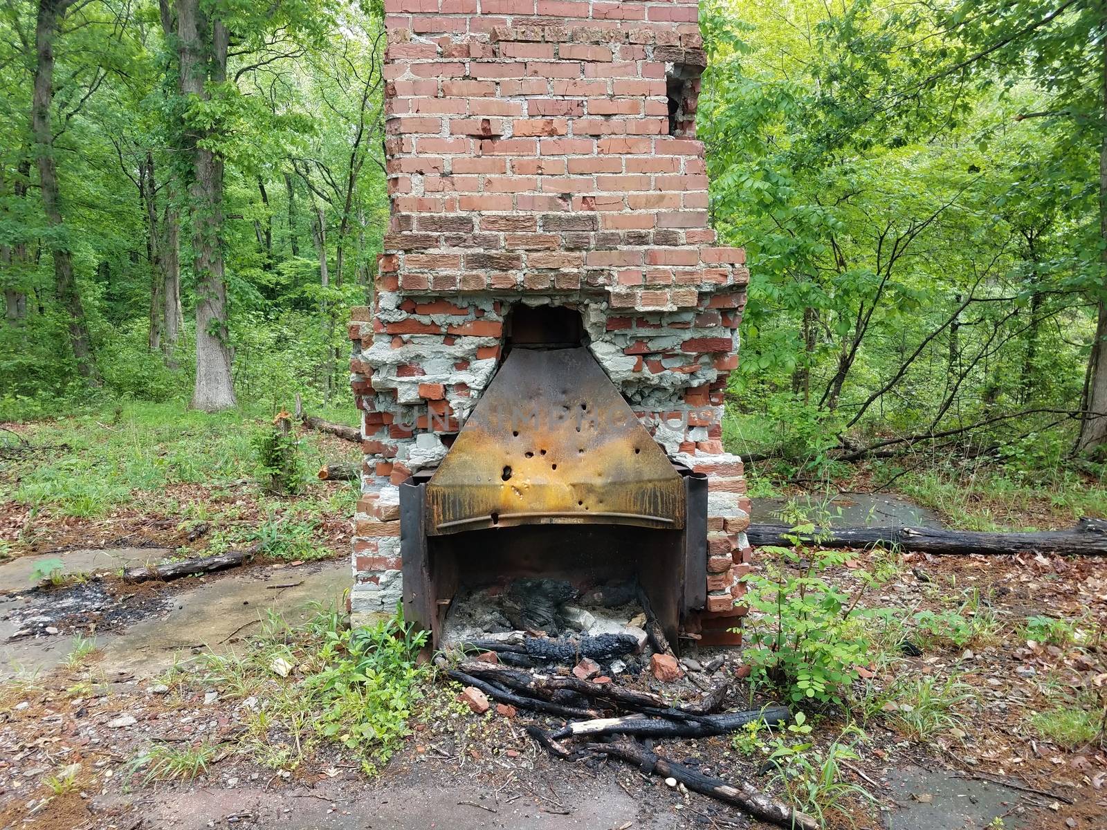 worn and weathered or dilapidated or damaged chimney and fireplace with holes in it