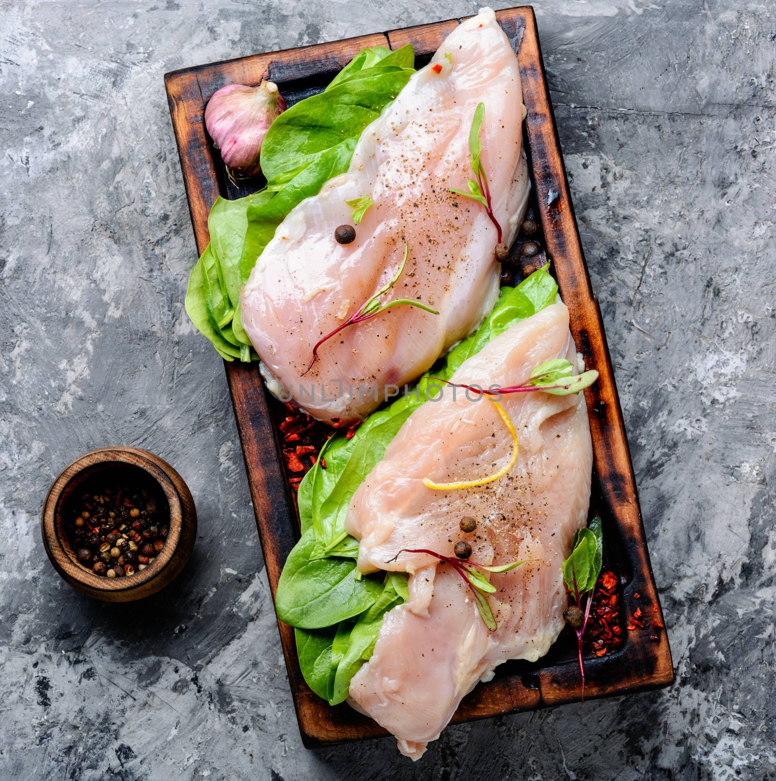 Fresh raw chicken on kitchen cutting board