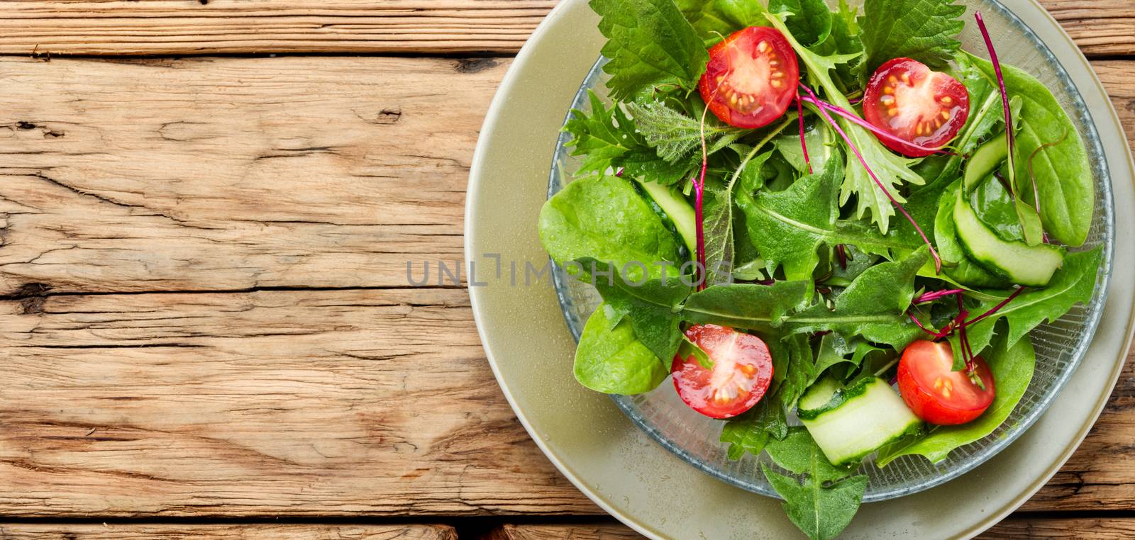 Healthy vegetable salad on rustic wooden background.Space for text