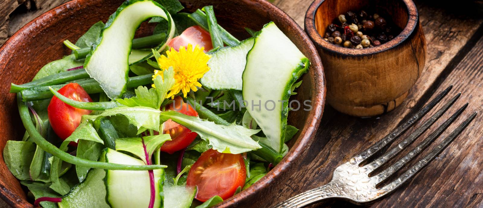 Healthy vegetable salad on rustic wooden background