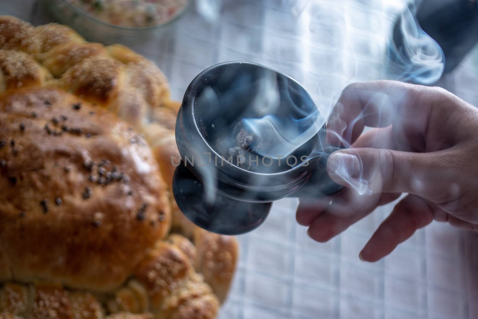 Smoke rising from Cresset on the table with food on ortodox easter