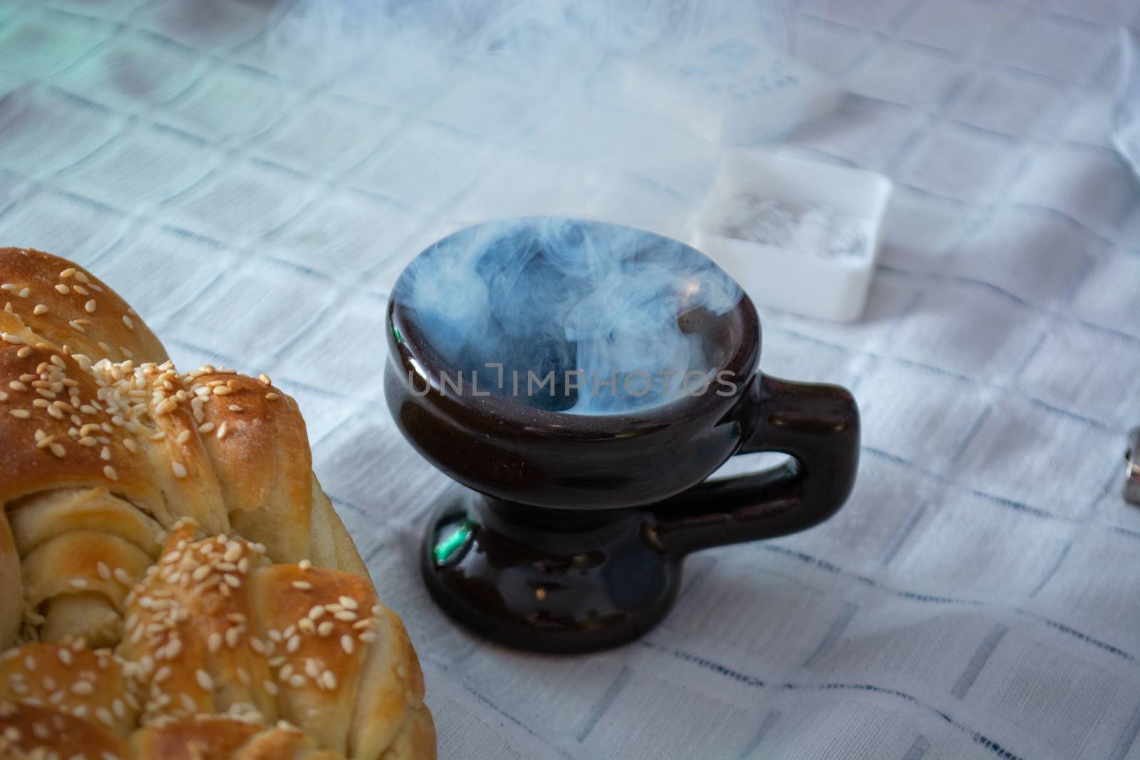 Smoke rising from Cresset on the table with food on ortodox easter
