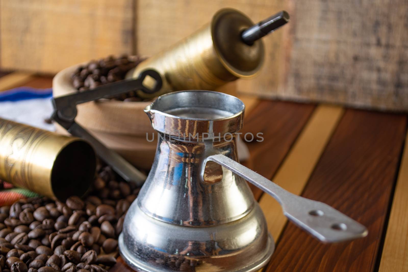 Coffee ready to be milled with old grinder. Coffee is in the table